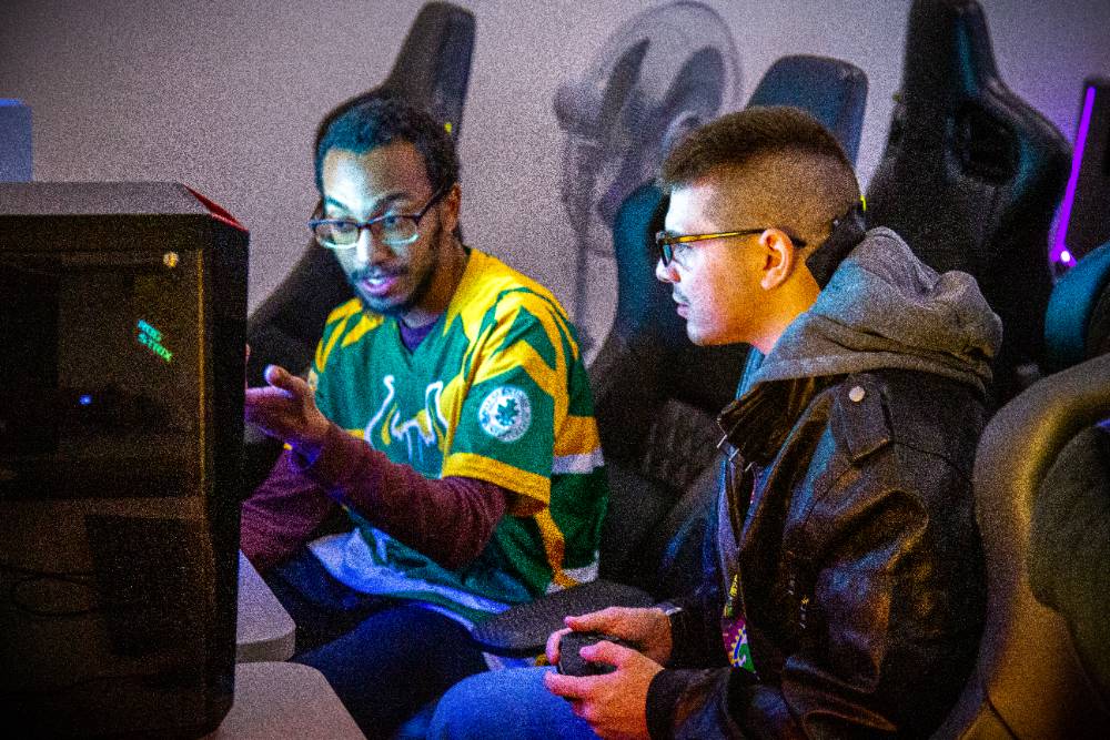 two male students in class and sitting in front of computers