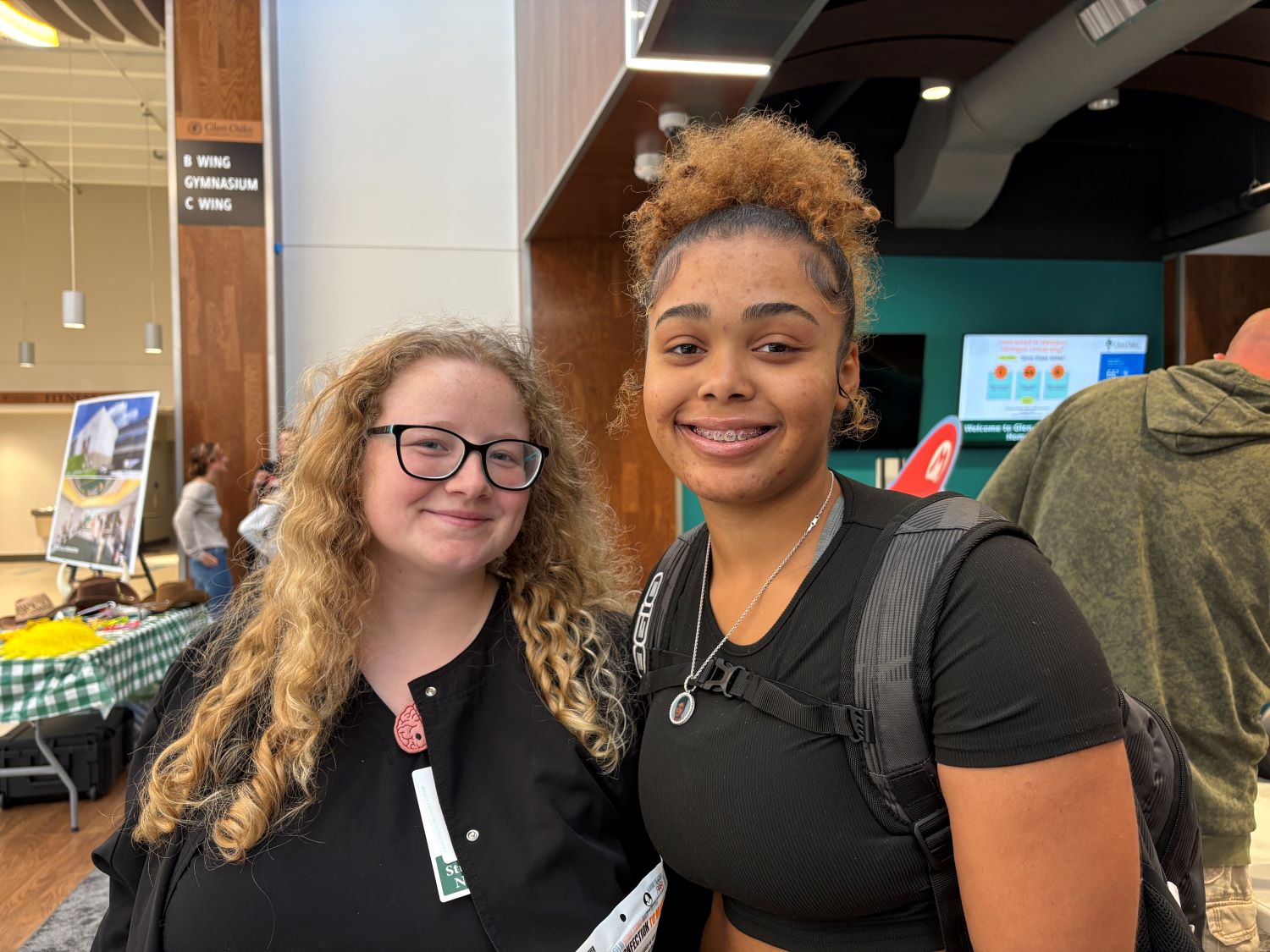 two female students facing the camera and smiling